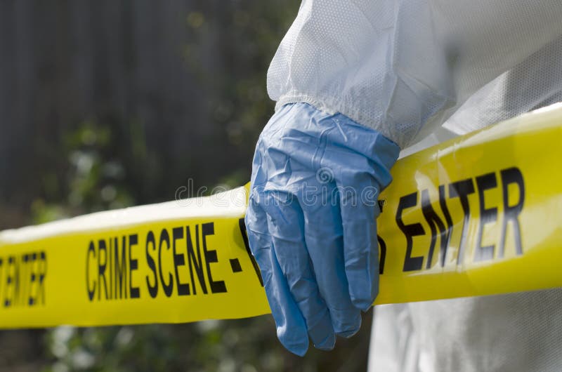 Forensic investigator working at a crime scene. Forensic investigator working at a crime scene