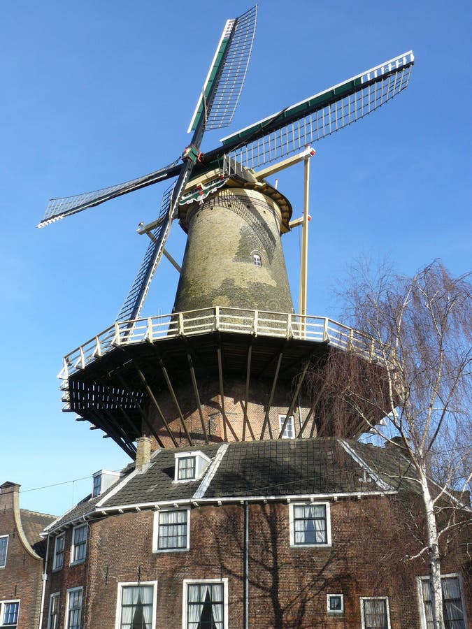 A corn wind mill and the millers home. A corn wind mill and the millers home