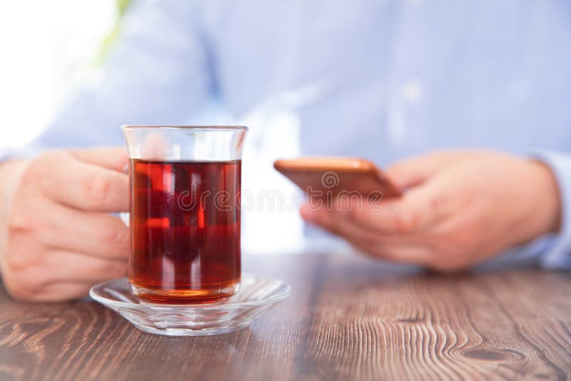 Tea drinkers playing with mobile phones. Tea drinkers playing with mobile phones.