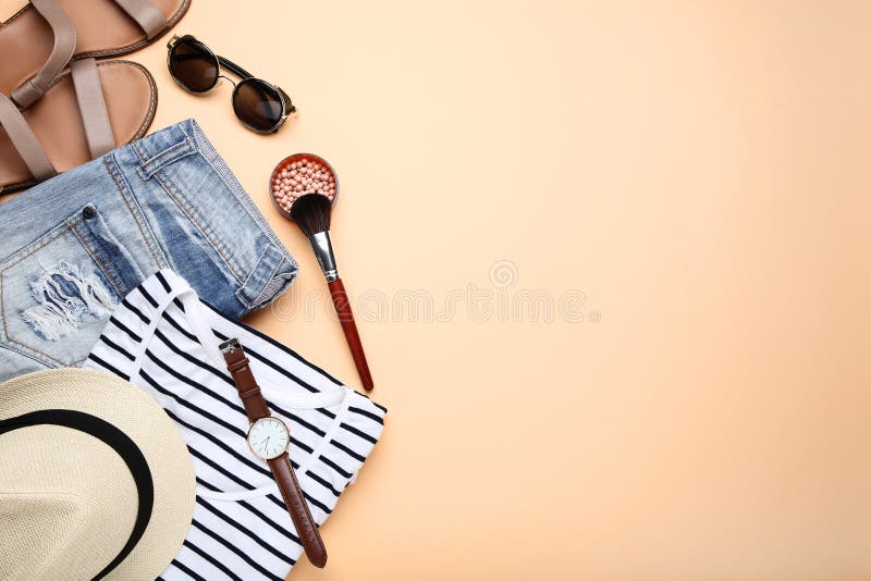 Modern women`s clothes with accessories and makeup cosmetics on colorful background. Modern women`s clothes with accessories and makeup cosmetics on colorful background