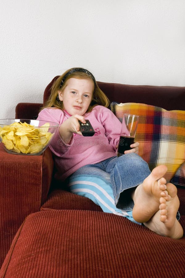 Zapping TV, chips and cola. Zapping TV, chips and cola