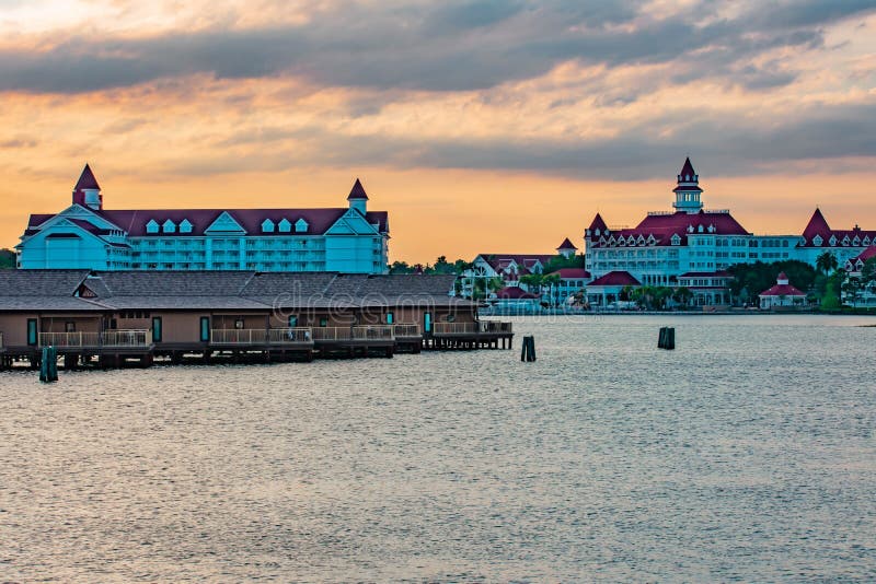 Orlando, Florida. April 02, 2019. Polynesian Resort cabins and Disney`s Grand Floridian Resort & Spa on sunset background at Walt Disney World . Orlando, Florida. April 02, 2019. Polynesian Resort cabins and Disney`s Grand Floridian Resort & Spa on sunset background at Walt Disney World .