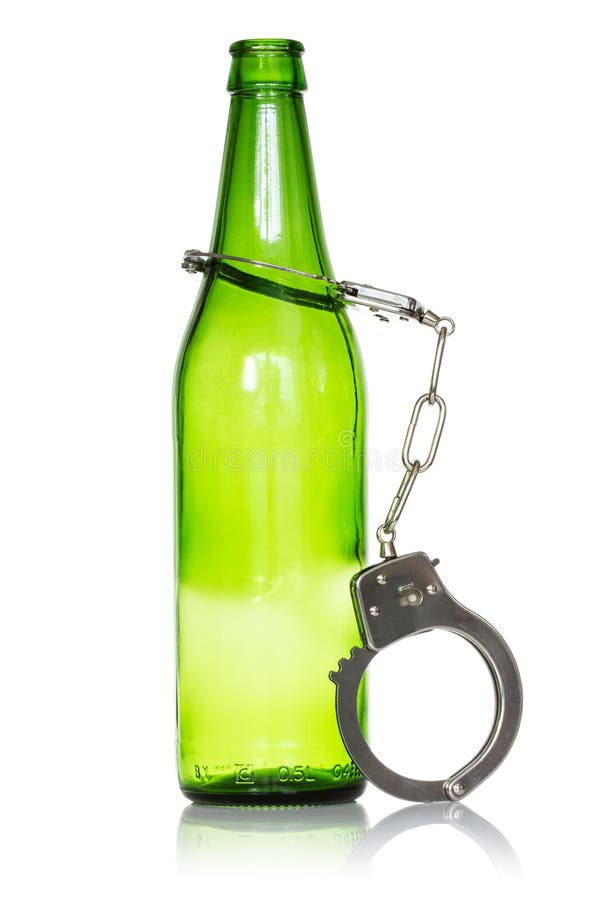 Alcoholism and drunk driving concept. Bottle and handcuffs over a white background. Alcoholism and drunk driving concept. Bottle and handcuffs over a white background