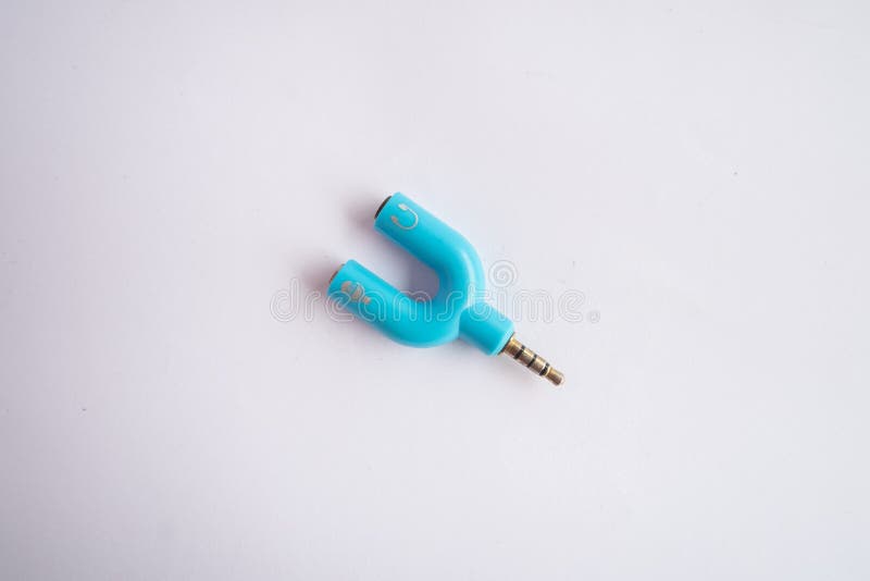 Audio Splitter 3.5mm For Microphone and Headphone. Audio Splitter allows to connect mic and headphone to the same jack concept  on white background. Audio Splitter 3.5mm For Microphone and Headphone. Audio Splitter allows to connect mic and headphone to the same jack concept  on white background