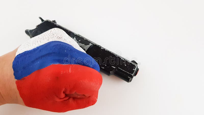 a hand painted in the colors of the Russian flag holds a gun, a pistol on a white background. a hand painted in the colors of the Russian flag holds a gun, a pistol on a white background.