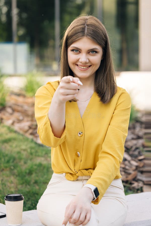 Beautiful european ukraininan girl pointing index finger at camera inviting with hand gesture. Young ethnic happy woman calling to showing something and speaking body language. Hey you, come here. Beautiful european ukraininan girl pointing index finger at camera inviting with hand gesture. Young ethnic happy woman calling to showing something and speaking body language. Hey you, come here.