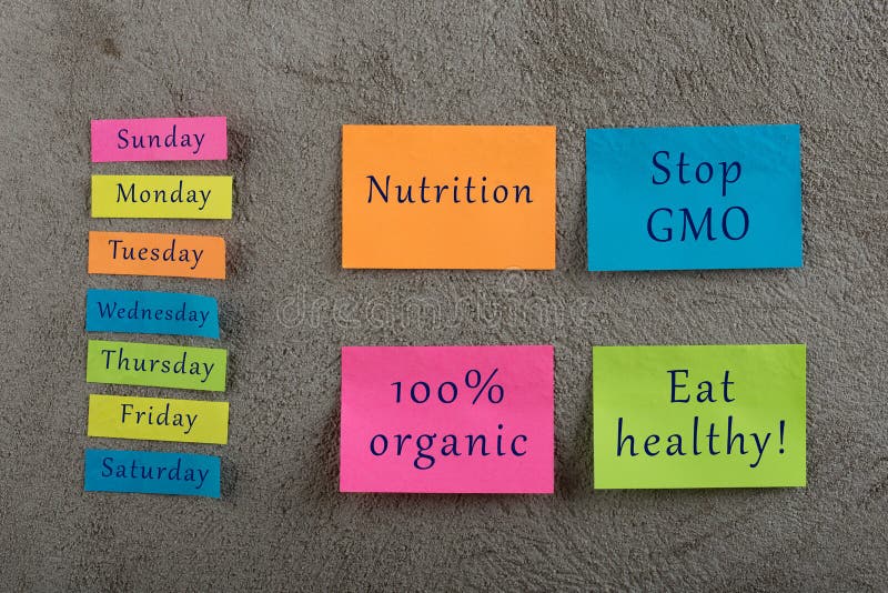 Diet plan concept - Many colorful sticky note with words nutrition, eat healthy, stop gmo, 100 percent organic and days of week on grey cement background. Diet plan concept - Many colorful sticky note with words nutrition, eat healthy, stop gmo, 100 percent organic and days of week on grey cement background