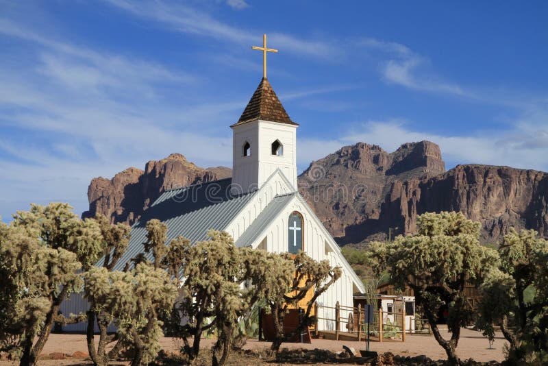 This chapel, located in Apache Junction, Arizona/USA was used in many western movies; nowadays it serves as wedding and as Elvis memorial church; in the foreground: cholla cacti, in the background Superstition Mountains. A movie jail is just visible on the right. Interior of the church: See: 27272600. This chapel, located in Apache Junction, Arizona/USA was used in many western movies; nowadays it serves as wedding and as Elvis memorial church; in the foreground: cholla cacti, in the background Superstition Mountains. A movie jail is just visible on the right. Interior of the church: See: 27272600