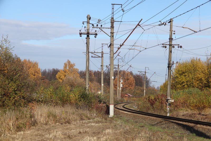 Electrified railway track, yellow autumn bushes, autumn background. Electrified railway track, yellow autumn bushes, autumn background.