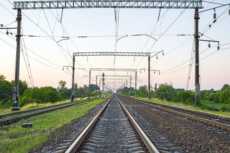 Electrified Railway - tracks, concrete sleepers, traffic lights and power lines. Electrified Railway - tracks, concrete sleepers, traffic lights and power lines