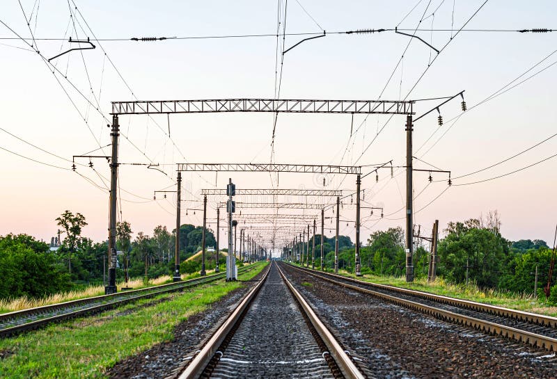 Electrified Railway - tracks, concrete sleepers, traffic lights and power lines. Electrified Railway - tracks, concrete sleepers, traffic lights and power lines