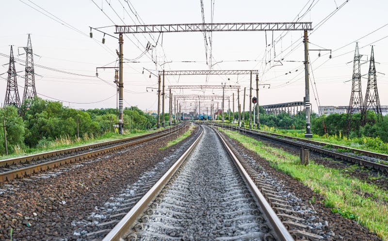 Electrified Railway - tracks, concrete sleepers, traffic lights and power lines. Electrified Railway - tracks, concrete sleepers, traffic lights and power lines
