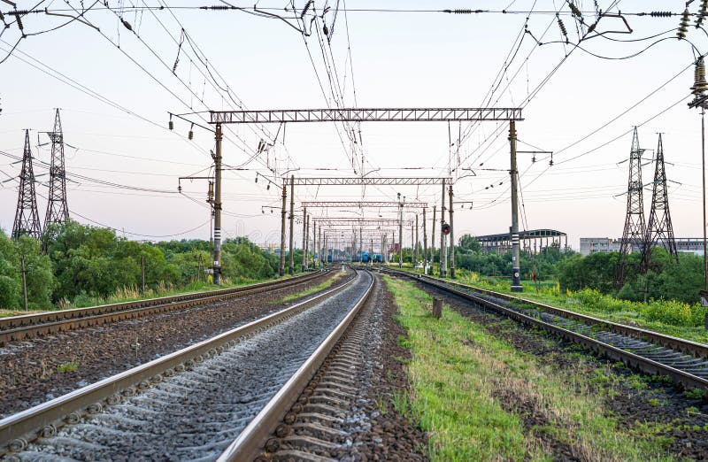 Electrified Railway - tracks, concrete sleepers, traffic lights and power lines. Electrified Railway - tracks, concrete sleepers, traffic lights and power lines