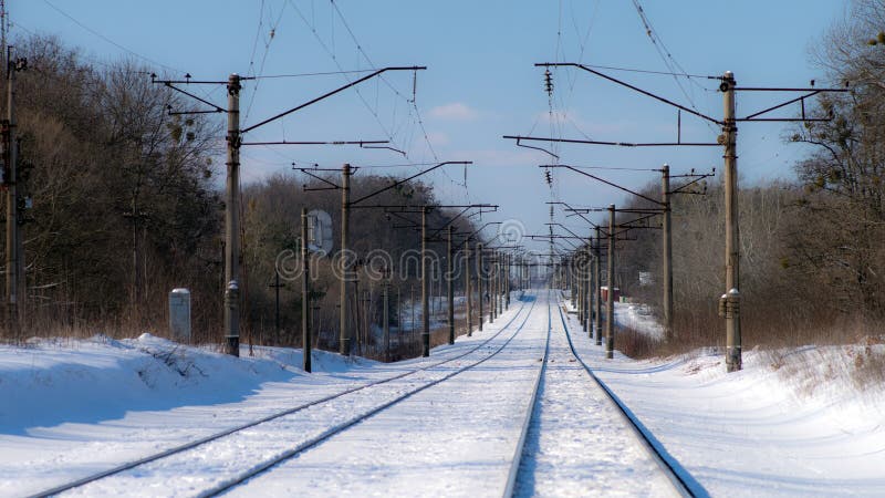 Two branches of the electrified railroad stretched into the distance. Selective focus. Two branches of the electrified railroad stretched into the distance. Selective focus