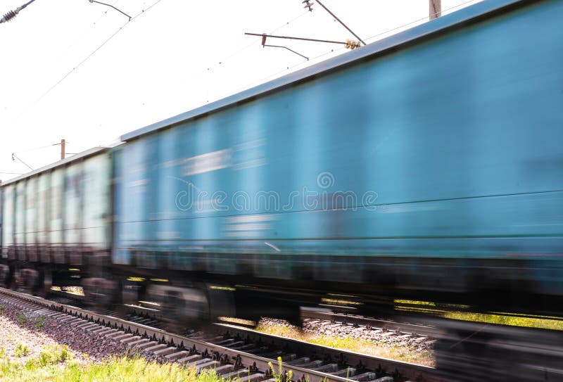 Train with freight wagons in motion on electrified railway in summer day period. Train with freight wagons in motion on electrified railway in summer day period