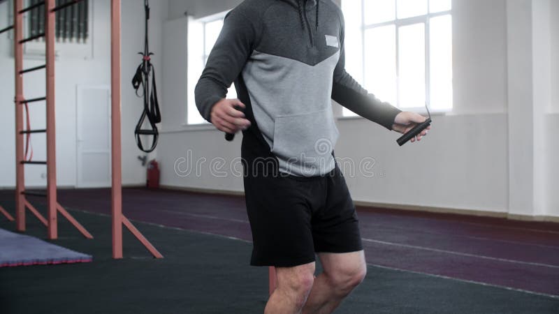 男子运动员在健身房中用跳绳锻炼的中段