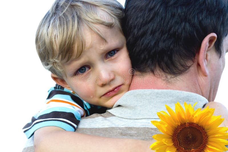 Young boy crying on his father's shoulder, while holding a yellow flower in one hand. Young boy crying on his father's shoulder, while holding a yellow flower in one hand.