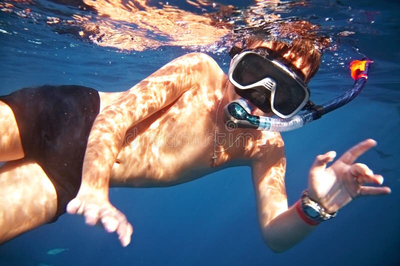 Boy floats under water in the sea. Boy floats under water in the sea