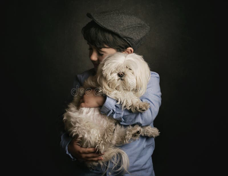 Boy hugging his dog on black background. Boy hugging his dog on black background