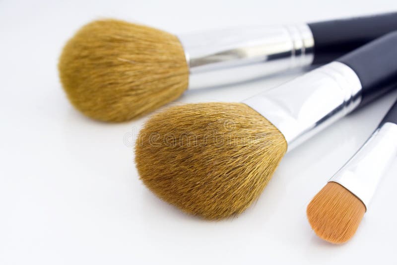 Set of three makeup brushes for face powder, concealer and eye shadow, on white background. Set of three makeup brushes for face powder, concealer and eye shadow, on white background.