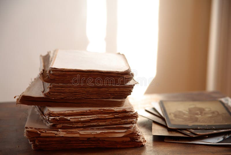 Old books and photos in sepia with shallow depth of field. Old books and photos in sepia with shallow depth of field.