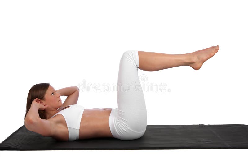 Fit and muscular young caucasian woman exercising situps on a black mat. Fit and muscular young caucasian woman exercising situps on a black mat