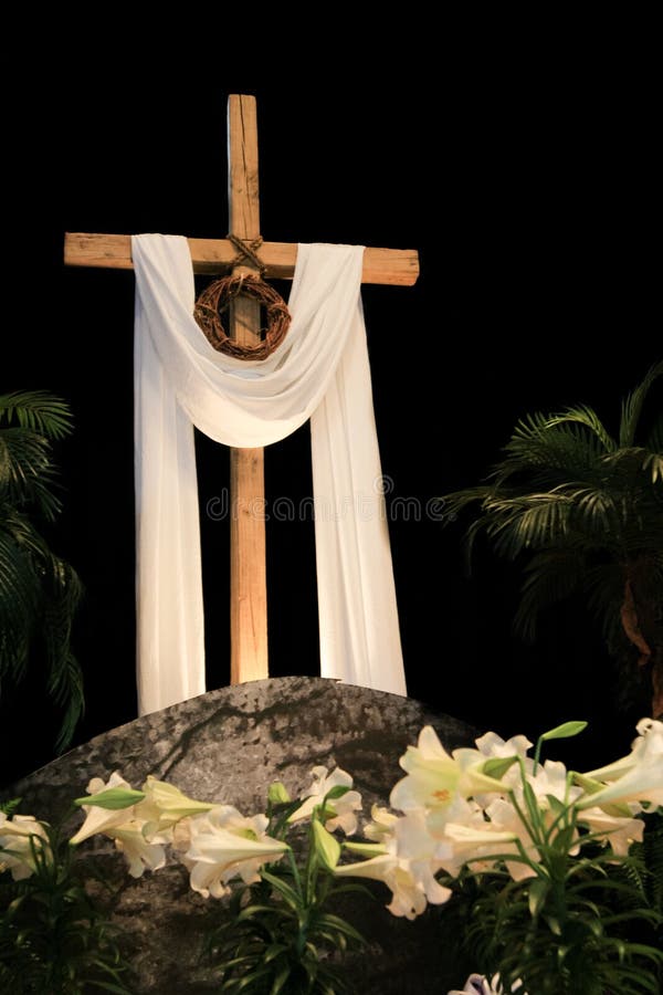 White Easter lilies, a wooden cross and symbolic Crown of Thorns signifying the death and resurrection of Jesus Christ. White Easter lilies, a wooden cross and symbolic Crown of Thorns signifying the death and resurrection of Jesus Christ.