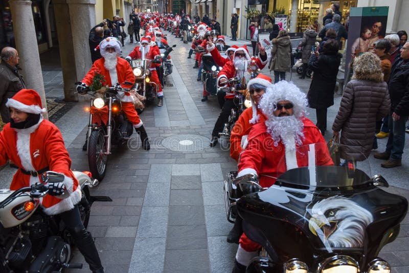 Lugano, Switzerland - 3 December 2016: Christmas parade of Santa Clauses who drive a motorcycle on the streets of Lugano on the italian part of Switzerland. Lugano, Switzerland - 3 December 2016: Christmas parade of Santa Clauses who drive a motorcycle on the streets of Lugano on the italian part of Switzerland