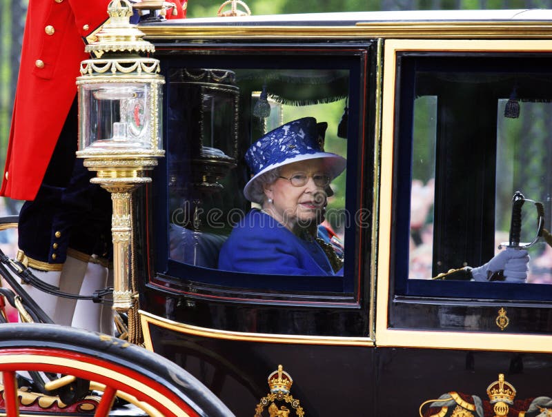 London, UK - June 15, 2013: Queen Elizabeth II seat on the Royal Coach at Queen's Birthday Parade. Queen's Birthday Parade take place to Celebrate Queen's Official Birthday in every June in London. London, UK - June 15, 2013: Queen Elizabeth II seat on the Royal Coach at Queen's Birthday Parade. Queen's Birthday Parade take place to Celebrate Queen's Official Birthday in every June in London.