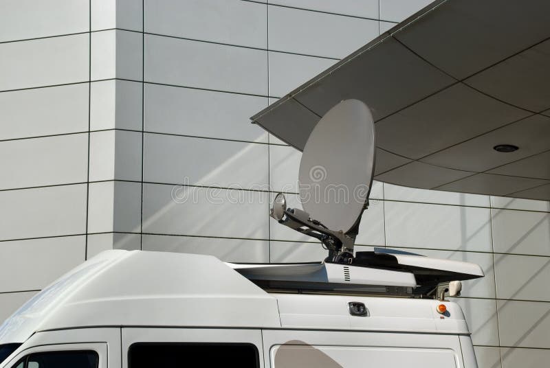 Mobile satellite dish on a van or car in an urban environment in front of modern architecture, used by the news media to cover remote events live. Mobile satellite dish on a van or car in an urban environment in front of modern architecture, used by the news media to cover remote events live.