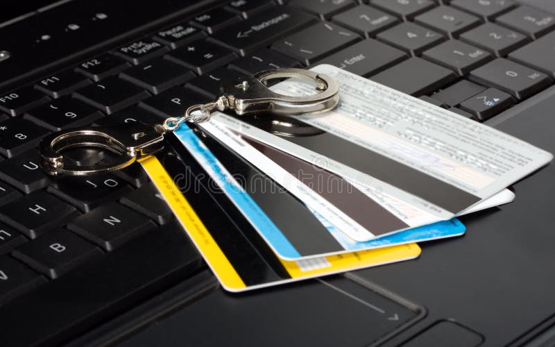 Credit card of handcuffs on a computer keyboard. Credit card of handcuffs on a computer keyboard