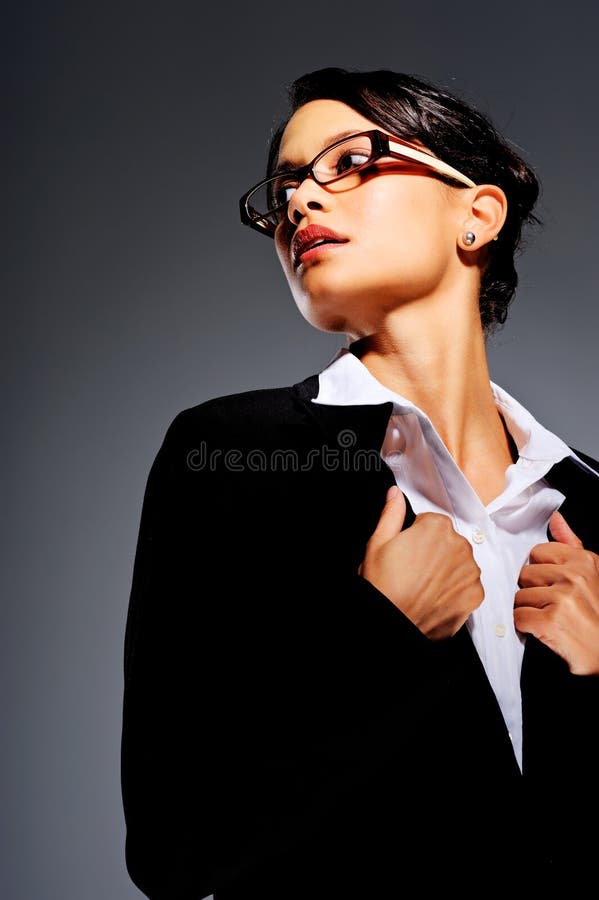 Mixed race woman in glasses holding the lapels of her business suit. Mixed race woman in glasses holding the lapels of her business suit