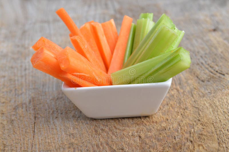 Bowl of carrot and celery sticks on wooden background. Bowl of carrot and celery sticks on wooden background