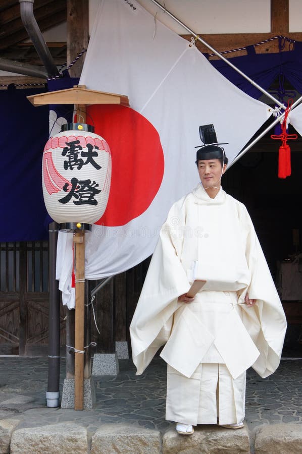 One shintoist standing up in front of a temple in Shirakawago, Japan, near the city of Takayama. One shintoist standing up in front of a temple in Shirakawago, Japan, near the city of Takayama