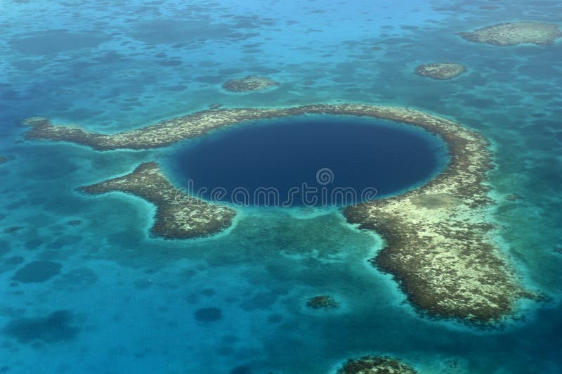 Aerial shot of the Blue Hole, a natural phenomena and popular dive spot off the coast of Belize made famous by Jacque Cousteau. Aerial shot of the Blue Hole, a natural phenomena and popular dive spot off the coast of Belize made famous by Jacque Cousteau.