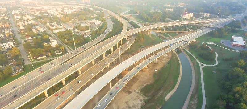 Panorama aerial I-10, I-45 freeway and suburban residential houses in Northeast Houston, Texas, USA. Highway lane under construction, massive intersection, stack interchange, elevated road overpass. Panorama aerial I-10, I-45 freeway and suburban residential houses in Northeast Houston, Texas, USA. Highway lane under construction, massive intersection, stack interchange, elevated road overpass