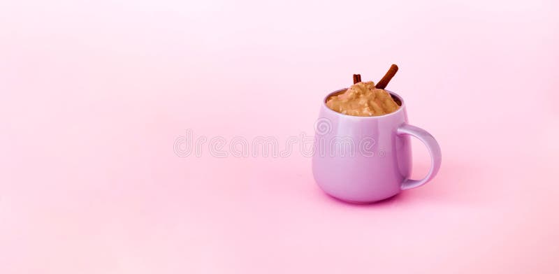 Dalgona Coffee in purple ceramic cup on pink background. Trendy cold Korean and Indian drink. Sustainable Wellness. Close-up, copy space. Dalgona Coffee in purple ceramic cup on pink background. Trendy cold Korean and Indian drink. Sustainable Wellness. Close-up, copy space