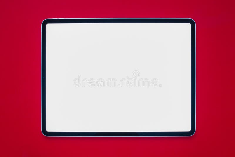 Calgary, Alberta. Canada. Feb 3, 2021. A iPad Pro with a white screen on a red background. Calgary, Alberta. Canada. Feb 3, 2021. A iPad Pro with a white screen on a red background