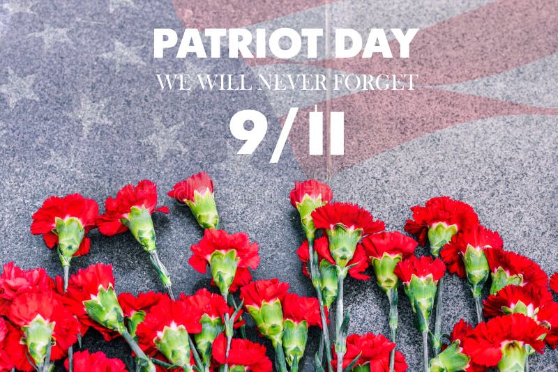 Carnations on the memorial with the American flag and the phrase patriots Day. September 11. We will never forget. Anniversary of the attack. Carnations on the memorial with the American flag and the phrase patriots Day. September 11. We will never forget. Anniversary of the attack.