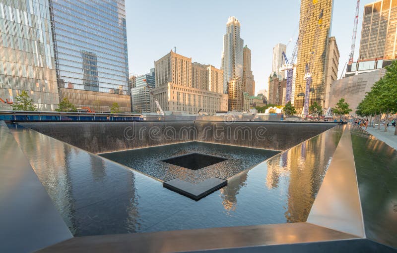 NEW YORK CITY - JUNE 12, 2013: NYC's 9/11 Memorial at World Trade Center Ground Zero seen on June 12, 2013. The memorial was dedicated on the 10th anniversary of the Sept. 11, 2001 attacks. NEW YORK CITY - JUNE 12, 2013: NYC's 9/11 Memorial at World Trade Center Ground Zero seen on June 12, 2013. The memorial was dedicated on the 10th anniversary of the Sept. 11, 2001 attacks.