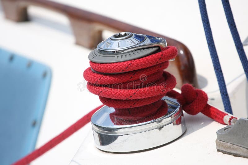 Winch and red rope on a sailboat. Winch and red rope on a sailboat