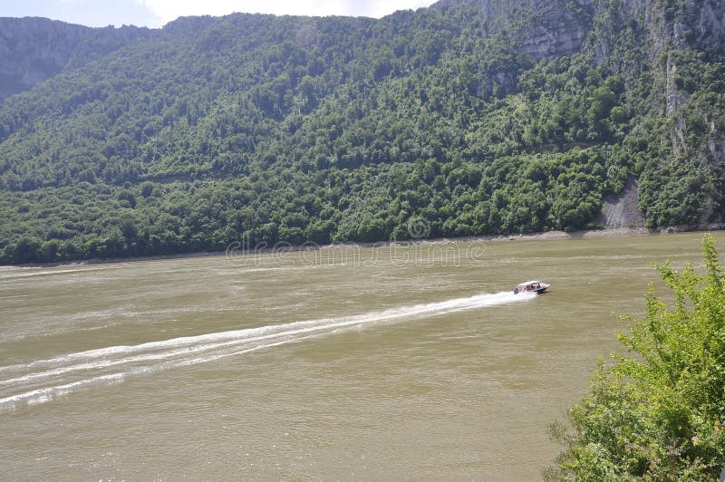 Transporter Ship on Danube river at Cazane Gorge in Romania on june 7 2015. Transporter Ship on Danube river at Cazane Gorge in Romania on june 7 2015