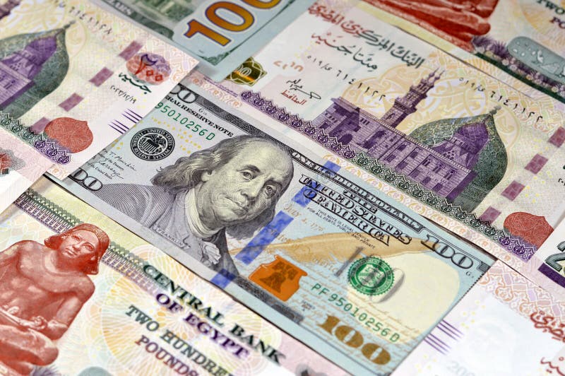 USD American cash of 100 dollars and Egyptian money banknotes of 200 EGP LE two hundred pounds bills, money exchange rates of Egypt and United states of America, inflation and economy concept. USD American cash of 100 dollars and Egyptian money banknotes of 200 EGP LE two hundred pounds bills, money exchange rates of Egypt and United states of America, inflation and economy concept