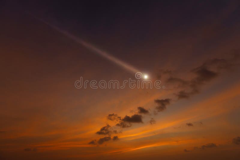 Bright shooting star in sunset cloudy sky. Bright shooting star in sunset cloudy sky