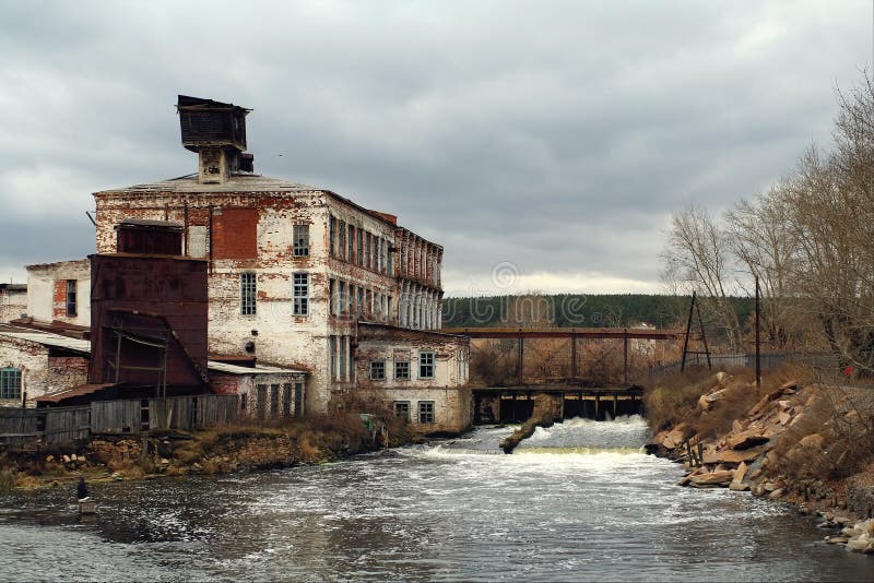 The old destroyed house above water and small dam. The old destroyed house above water and small dam