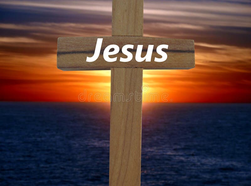 A cross with the name of Jesus written on it with a sunset backround. A cross with the name of Jesus written on it with a sunset backround.