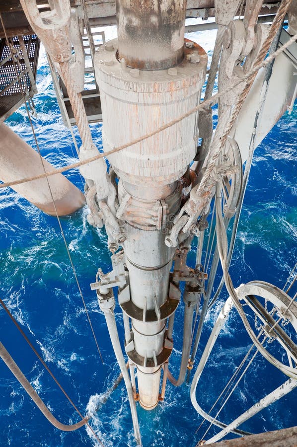 Telescopic joint hanging below a rotary table of a semi-submersible drilling unit offshore Vietnam. Numerous lines and pods are connected to ensure smooth wireline logging operations which were being conducted at the time of shooting the photo. Telescopic joint hanging below a rotary table of a semi-submersible drilling unit offshore Vietnam. Numerous lines and pods are connected to ensure smooth wireline logging operations which were being conducted at the time of shooting the photo.