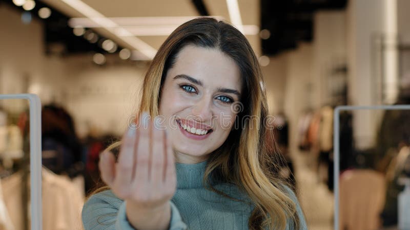 Portrait caucasian female shopper seductive smiling woman saleswoman owner of clothing store looking at camera making gesture hey you come here inviting waving hand offer discount tempting approaching. High quality 4k footage. Portrait caucasian female shopper seductive smiling woman saleswoman owner of clothing store looking at camera making gesture hey you come here inviting waving hand offer discount tempting approaching. High quality 4k footage