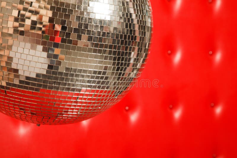 Dance mirror ball on red leather background. Dance mirror ball on red leather background