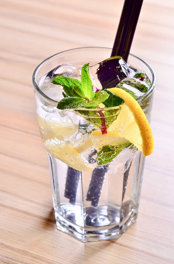 Homemade Summer Lemon Drink. Lemonade with tonic, water, mint in glass on table background. Copy space, Close up. Homemade Summer Lemon Drink. Lemonade with tonic, water, mint in glass on table background. Copy space, Close up.